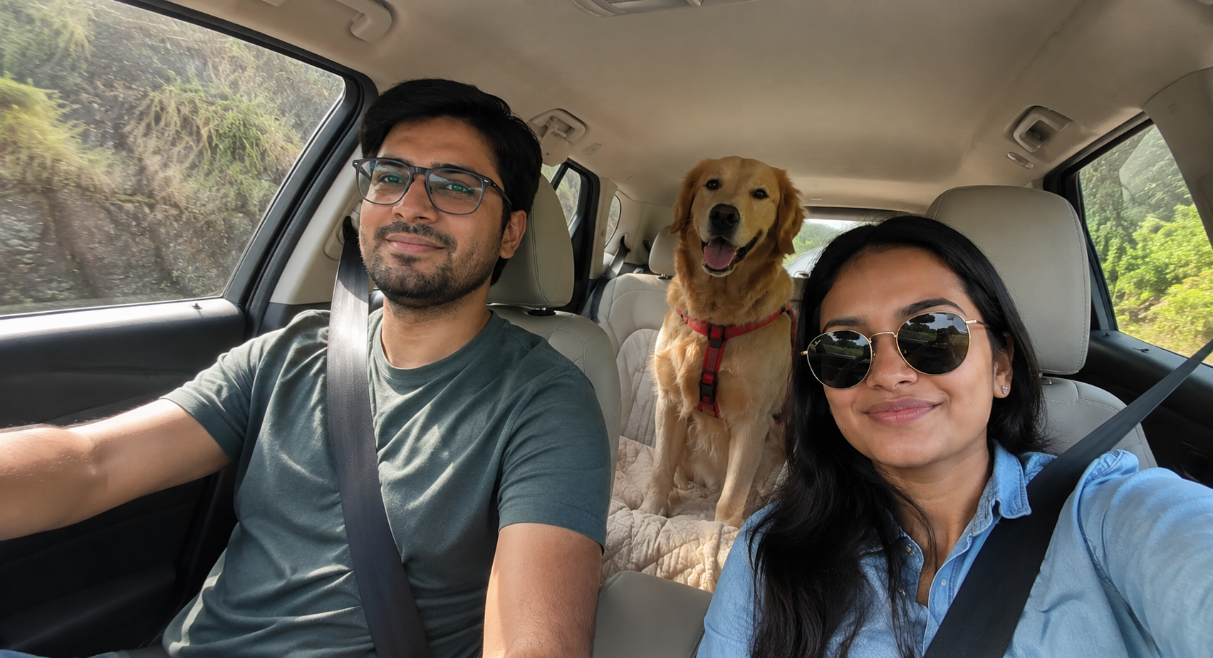 Golden Retriever traveling with two people in the back seat of a car during a road trip