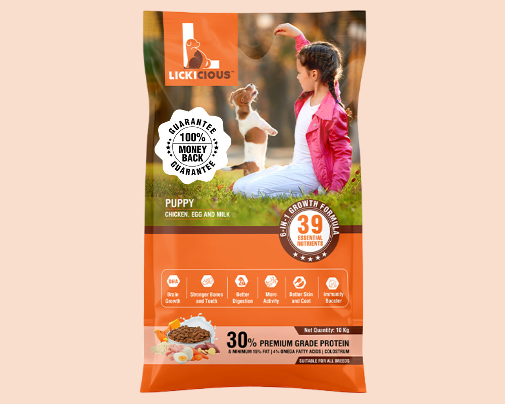 A bag of LickiCious Puppy Chicken Egg and Milk dry dog food, featuring a graphic design with a puppy and a girl in a park, set against a solid pale peach background.